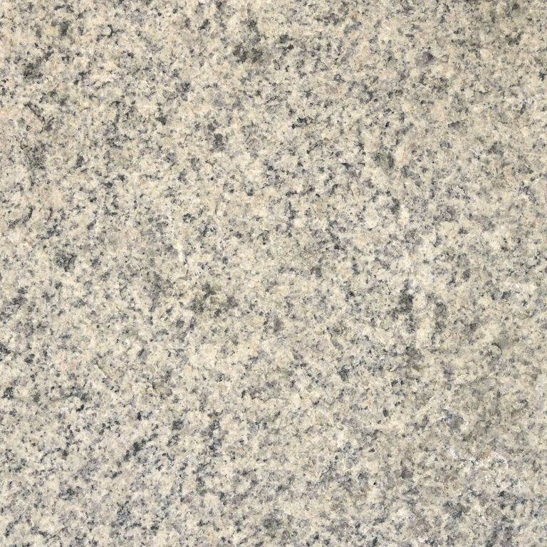 Color/Finish variation image for Cape Neddick Granite - Clear. The surface finish shown is flamed. The dominant color shown is beige; with gray, white, tan and cream secondaries. The color mix creates a warm feeling. Speckled and coarse speckled color patterns. Contains some mica.