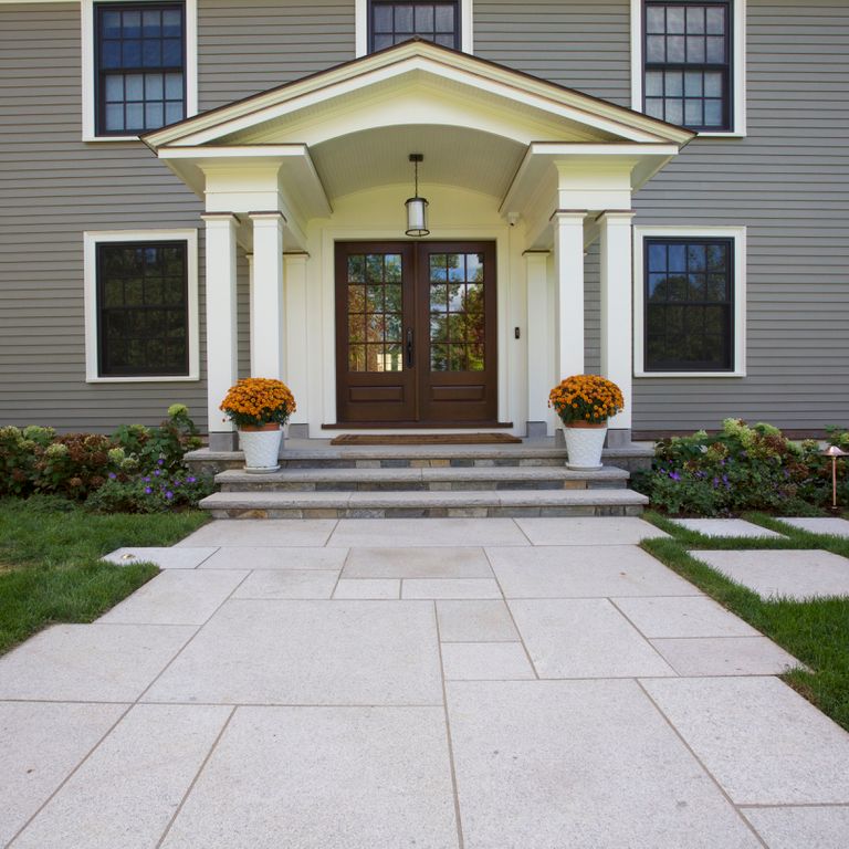 Feature image for Cape Neddick Granite - Clear. The image shows this material being used for path pavers and treads. The surface finish shown is flamed. The dominant color shown is gray; with beige and pink secondaries. The color mix creates a cool feeling. Fine speckled color pattern.