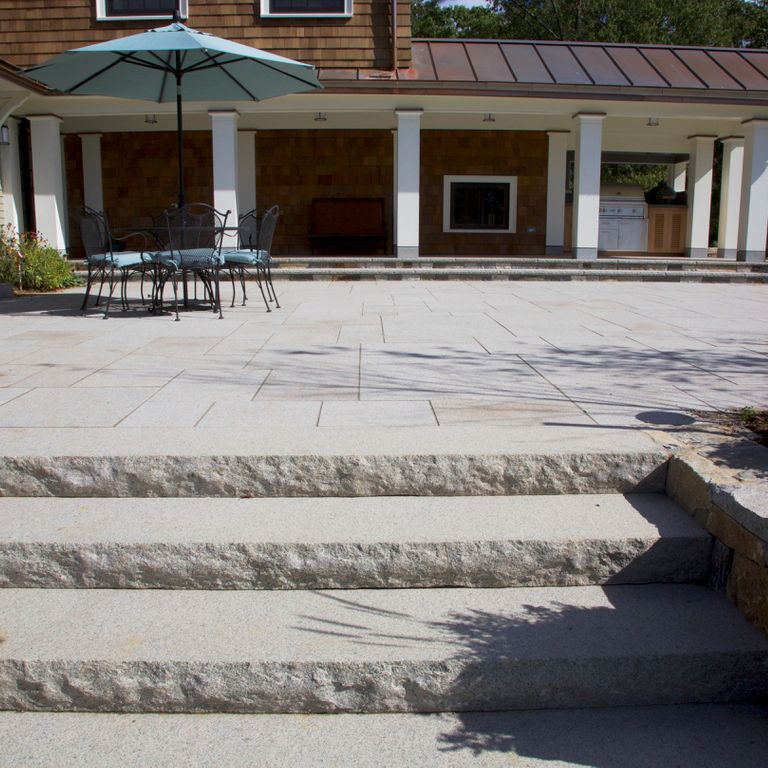 Application image for Granite - Cape Neddick Clear. The image shows this material being used for patio pavers and monolithic steps.