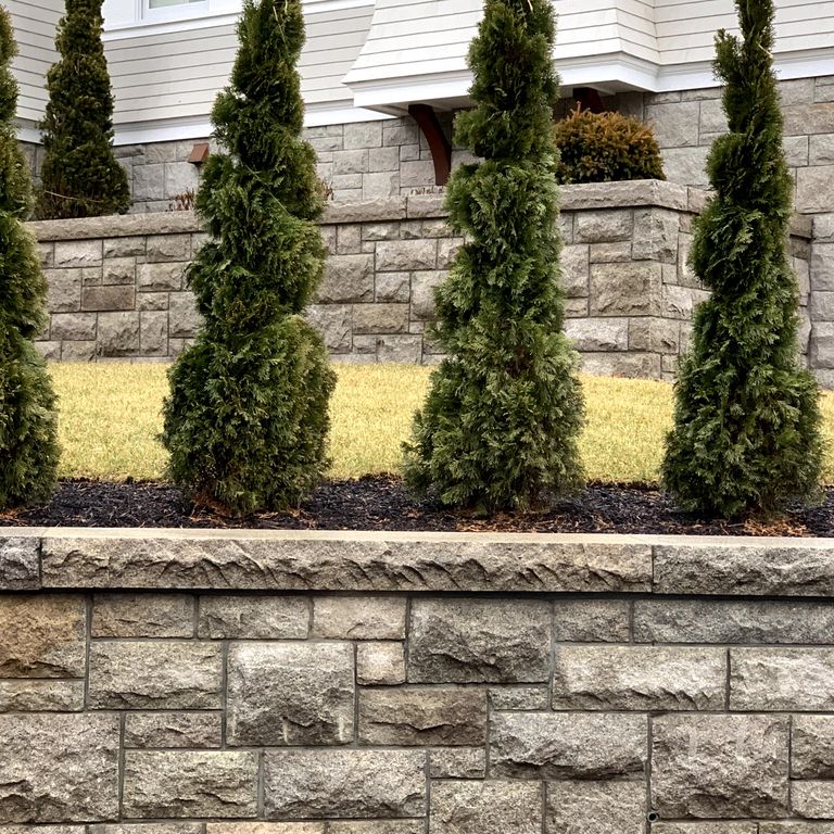 Application image for Granite - Cape Neddick Clear. The image shows this material being used in a landscape wallstone application.