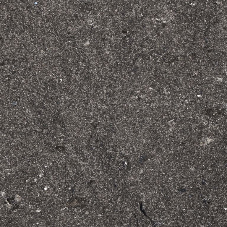 Feature image for Gneiss - Ultra Gray. The surface finish shown is natural cleft. Dominant colors shown are black and gray; with green, purple and tan secondaries. The color mix creates a cool feeling. Solid color pattern. Contains some mica and mineral inclusions.