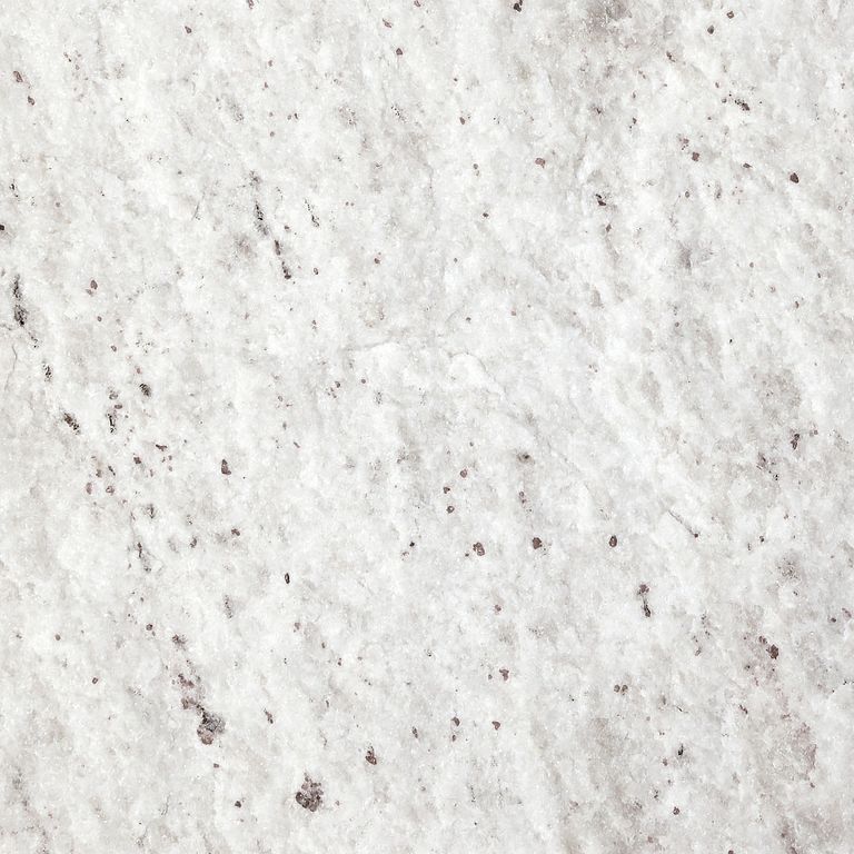 Best close-up image for Gneiss - Yellow Grumari. The surface finish shown is natural cleft. The dominant color shown is white; with beige, white and cream secondaries. The color mix creates a warm feeling. Cloudy color pattern. Contains some mica and mineral inclusions.