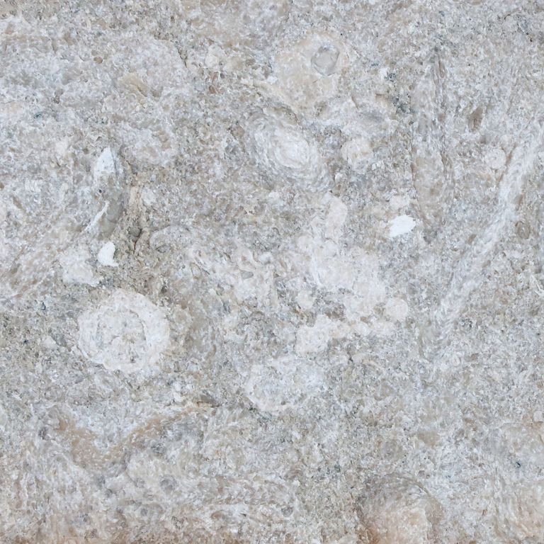 Color/Finish variation image for Veneto Olivo Limestone. The surface finish shown is split-face with flat plane. Dominant colors shown are gray, white and tan. The color mix creates a cool feeling. Speckled and blotched color patterns.