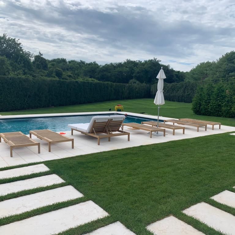 Application image for Veneto Beige Limestone. The image shows this material being used for pool coping, path pavers and pool deck pavers. The surface finish shown is flamed. Dominant colors shown are beige, tan and cream. The color mix creates a warm feeling. Regular color pattern.