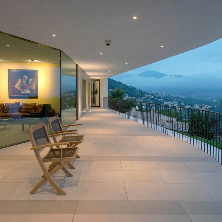 Feature image for Giallo Avorio Limestone. The image shows this material being used in a patio pavers application. The surface finish shown is honed. Dominant colors shown are brown, gray and tan; with beige and orange/rust secondaries. The color mix creates a warm feeling.