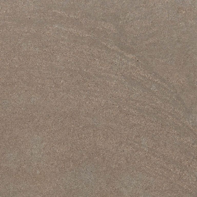 Best close-up image for Sandstone - Bretagna Brown. The surface finish shown is honed. Dominant colors shown are brown and tan; with green, purple and tan secondaries. The color mix creates a warm feeling. Regular and linear color patterns.