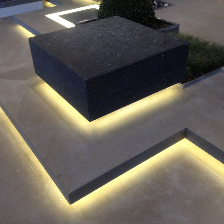 Feature image for Bretagna Brown Sandstone. The image shows this material being used for patio pavers and monolithic steps. The surface finish shown is a combination of sand blasted and waterjet. Dominant colors shown are brown, gray and purple. The color mix creates a warm feeling. Cloudy color pattern.