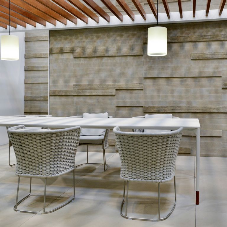 Application image for Sandstone - Bretagna Brown. The image shows this material being used for full bed veneer, thin veneer and interior cladding. The surface finish shown is a combination of honed, sand blasted and scratched. The dominant color shown is gray; with brown, green, orange/rust, purple and tan secondaries. The color mix creates a warm feeling. Regular color pattern.