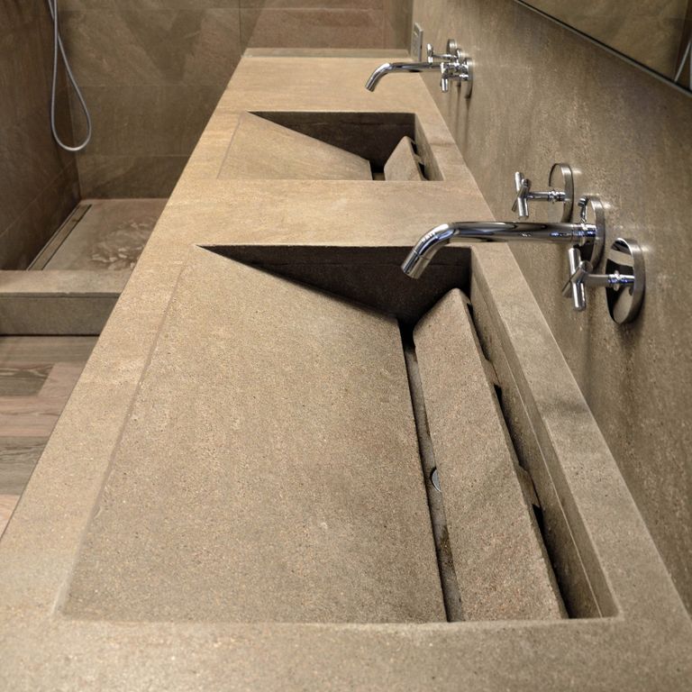 Application image for Bretagna Brown Sandstone. The image shows this material being used for sinks and thin veneer. The surface finish shown is honed. The dominant color shown is brown; with beige, gray, orange/rust and tan secondaries. The color mix creates a warm feeling. Regular color pattern.