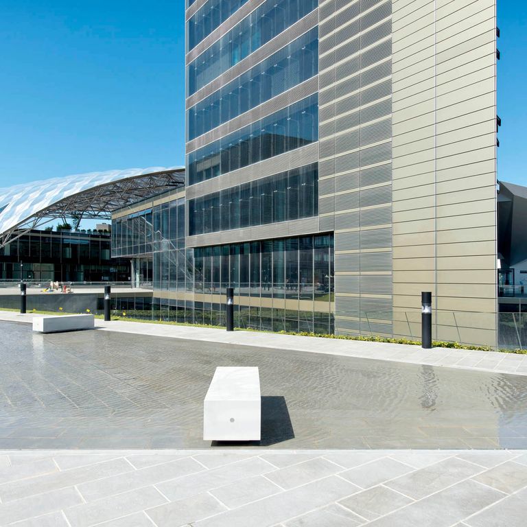 Application image for Pietra Forte Fiorentina Sandstone. The image shows this material being used for water features, seating & benches and patio pavers. The surface finish shown is honed. Dominant colors shown are blue, gray and pink; with beige, white and cream secondaries. The color mix creates a cool feeling. Regular color pattern.