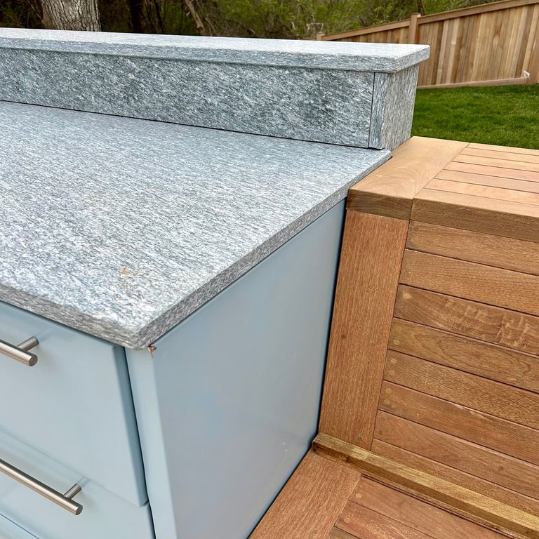 Application image for Pietra Italia Blue/Gray Gneiss. The image shows this material being used in a countertop slabs application. The surface finish shown is honed. Dominant colors shown are blue and gray. The color mix creates a cool feeling.