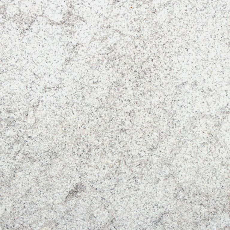 Feature image for Ocean Blue® Marble. The surface finish shown is sand blasted. Dominant colors shown are gray and cream. The color mix creates a cool feeling. Fine speckled and cloudy color patterns.