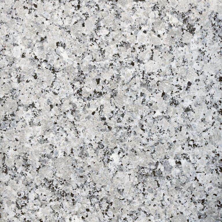 Best close-up image for Granite - Coral Gray. The surface finish shown is flamed. The dominant color shown is gray. The color mix creates a cool feeling. Coarse speckled color pattern.