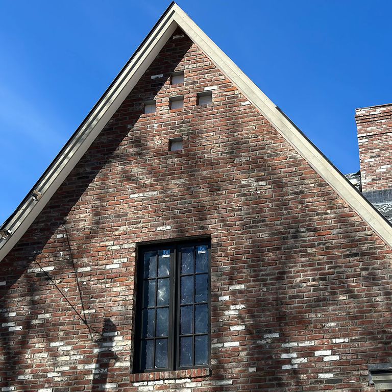 Application image for Reclaimed Rail Station Brick. The image shows this material being used for full bed veneer and thin veneer. The surface finish shown is . Dominant colors shown are brown, gray, red and white. The color mix creates a warm feeling. Regular color pattern.