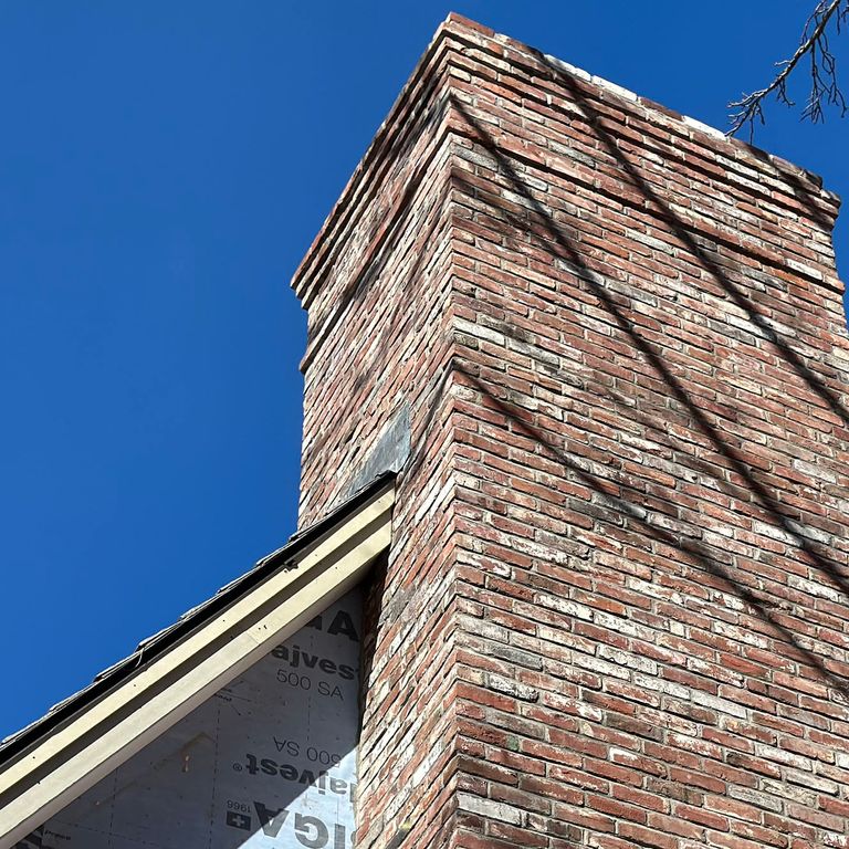 Application image for Reclaimed Rail Station Brick. The image shows this material being used for full bed veneer, thin veneer and chimney. The surface finish shown is . Dominant colors shown are brown, gray, red and white. The color mix creates a warm feeling. Regular color pattern.