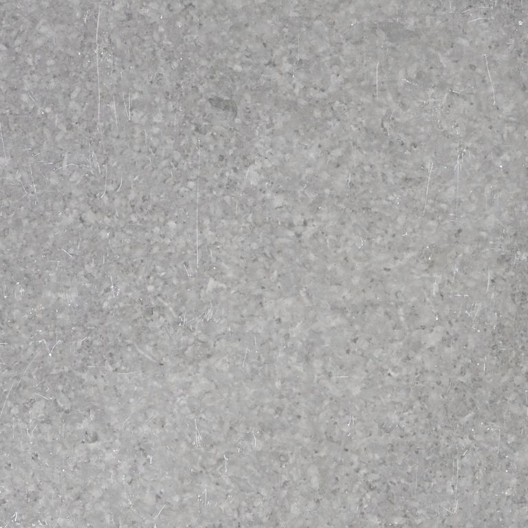 Best close-up image for Northern Bay Limestone. The surface finish shown is honed. Dominant colors shown are blue and gray; with beige, orange/rust, tan and cream secondaries. The color mix creates a cool feeling. Regular and fine speckled color patterns.