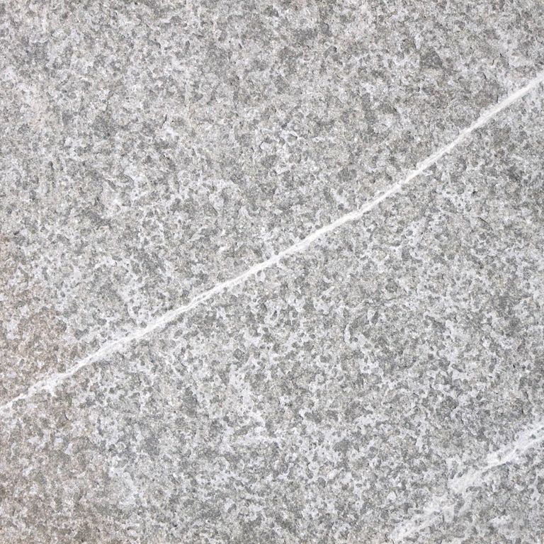 Best close-up image for Pietra Piase Limestone. The surface finish shown is flamed. The dominant color shown is gray. The color mix creates a cool feeling. Regular, veined and random color patterns.