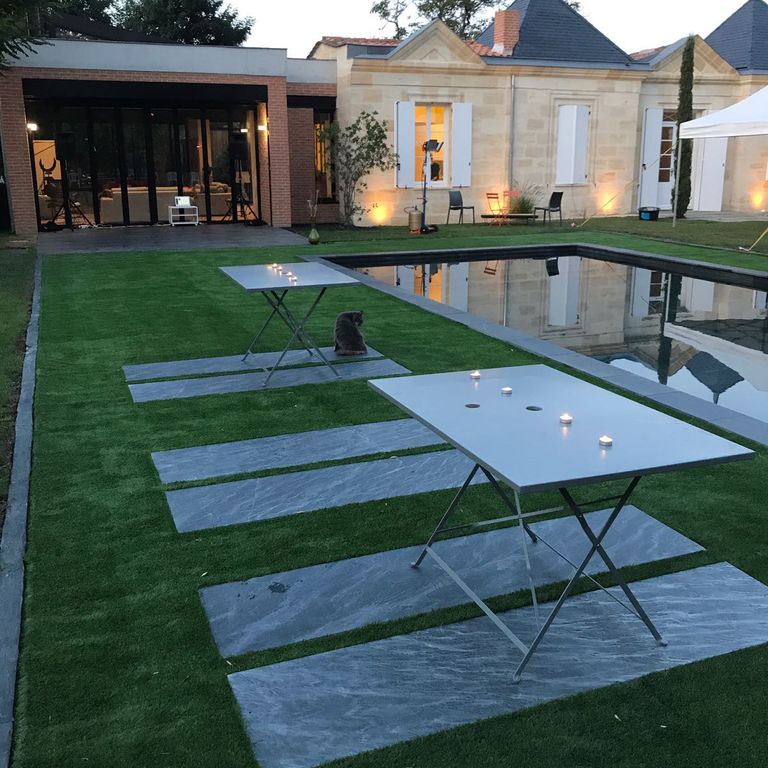 Application image for Iberian Gray Slate. The image shows this material being used in a patio pavers application. The surface finish shown is flamed. Dominant colors shown are blue and gray. Exhibits 