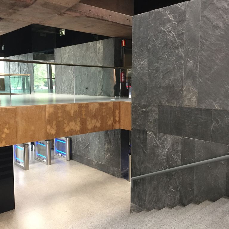 Application image for Iberian Gray Slate. The image shows this material being used in a thin veneer application. The dominant color shown is gray. Exhibits 