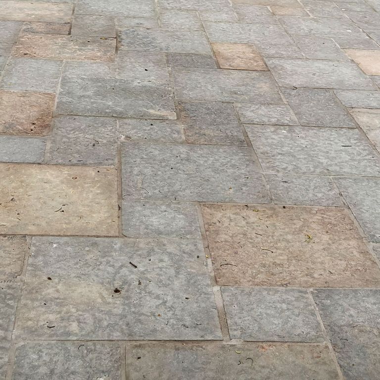 Best close-up image for Limestone - Madison - Full Color. The image shows this material being used in a patio pavers application. The surface finish shown is flamed. Dominant colors shown are gray and tan; with beige, blue, pink, purple, white and cream secondaries. The color mix creates a warm feeling. Regular and random color patterns. Contains mineral inclusions.