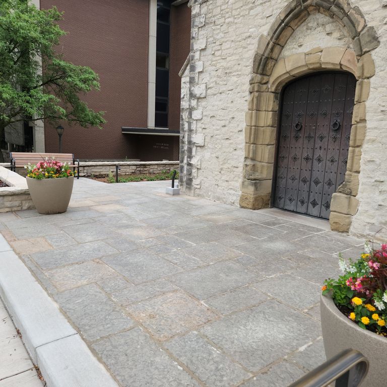 Application image for Limestone - Madison - Full Color. The image shows this material being used in a patio pavers application. The surface finish shown is flamed. The dominant color shown is gray. The color mix creates a warm feeling.