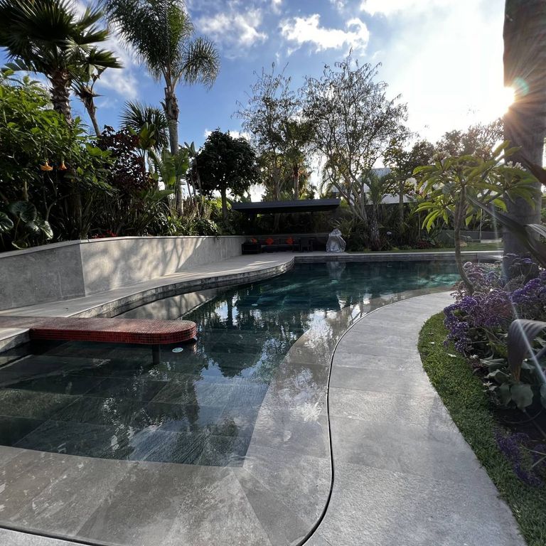 Feature image for Limestone - Casablanca. The image shows this material being used for pool coping and pool deck pavers. The surface finish shown is . The dominant color shown is gray. The color mix creates a cool feeling. Cloudy color pattern.