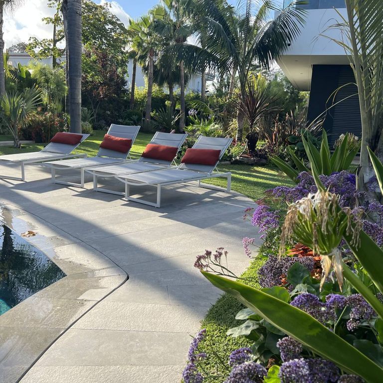 Application image for Limestone - Casablanca. The image shows this material being used for pool coping and pool deck pavers. The surface finish shown is . The dominant color shown is gray. The color mix creates a cool feeling.