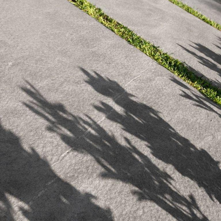 Application image for Casablanca Limestone. The image shows this material being used in a patio pavers application. The surface finish shown is flamed. The dominant color shown is gray. The color mix creates a warm feeling.