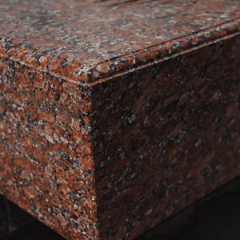 Application image for Granite - Red Crystal. The image shows this material being used in a monolithic steps application. Dominant colors shown are black and red. The color mix creates a warm feeling.