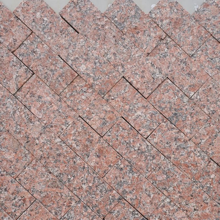 Application image for Granite - Red Crystal. The image shows this material being used in a thin veneer application. Dominant colors shown are gray and red. The color mix creates a warm feeling.
