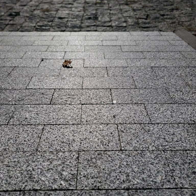 Application image for Granite - White House. The image shows this material being used in a patio pavers application. Dominant colors shown are gray and white. The color mix creates a cool feeling.