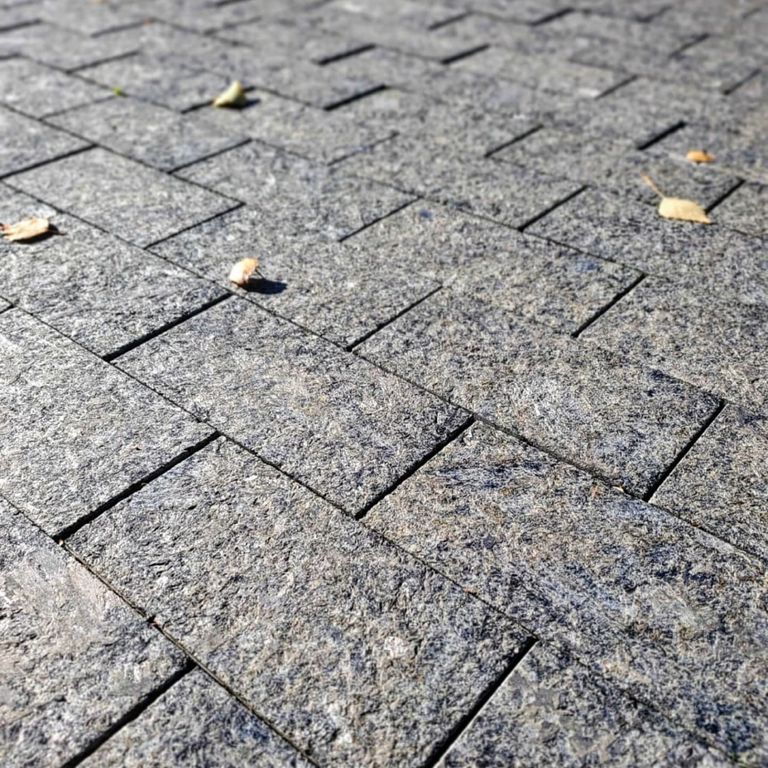 Application image for Labradorite - Blue Seven Oceans. The image shows this material being used in a patio pavers application. The dominant color shown is gray. The color mix creates a cool feeling.
