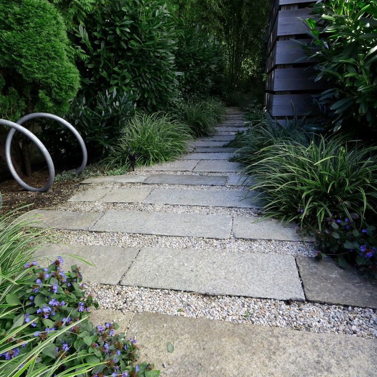 The image shows this material being used in a path pavers application. The dominant color shown is gray; with beige, blue, purple, white, tan and cream secondaries. The color mix creates a cool feeling. Regular and fine speckled color patterns.