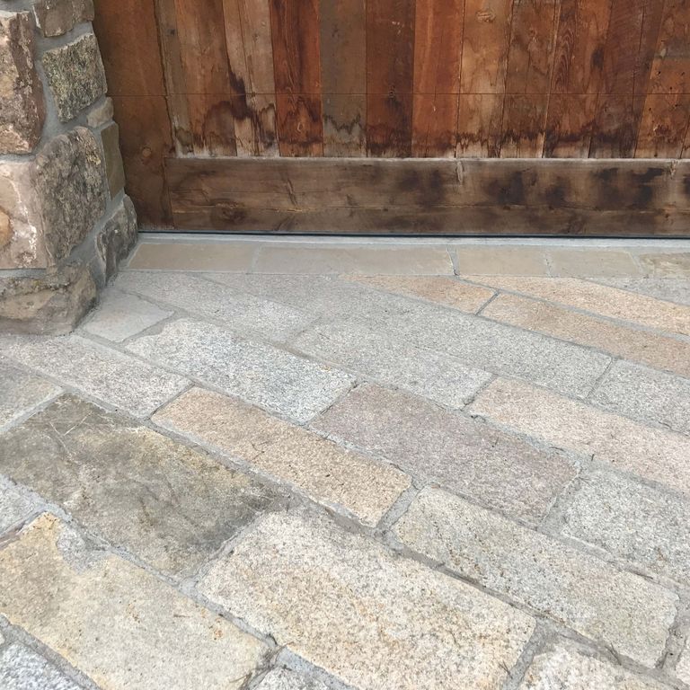 Application image for MARK 33b TESTING - Granite - Reclaimed Footworn Planks - Lona Test. The image shows this material being used for driveway pavers and patio pavers.