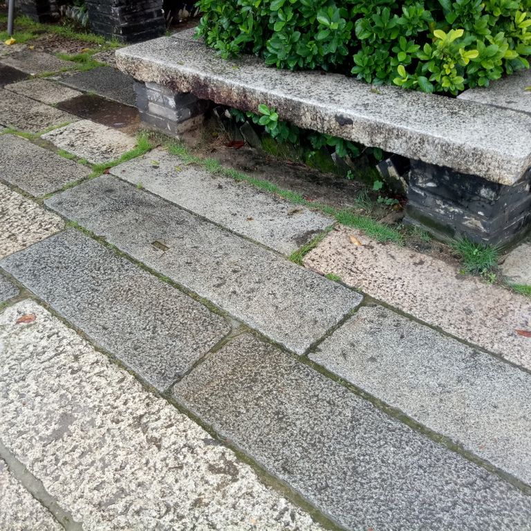 Application image for MARK 33b TESTING - Granite - Reclaimed Footworn Planks - Lona Test. The image shows this material being used for seating & benches and patio pavers.