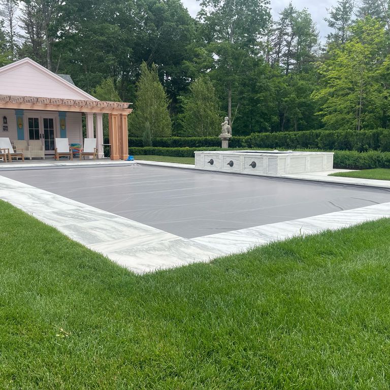Feature image for Marble - White Cloud. The image shows this material being used in a pool coping application. Dominant colors shown are gray, white and cream. The color mix creates a cool feeling.