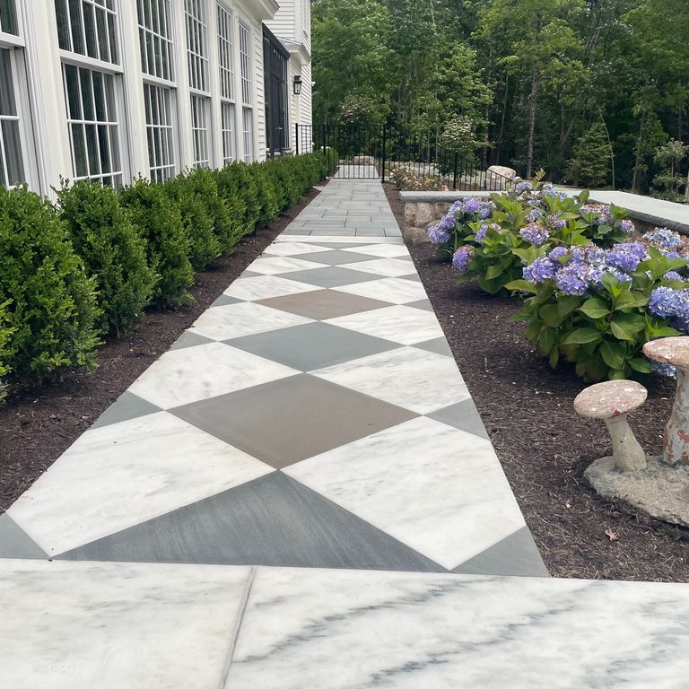 Application image for Marble - White Cloud. The image shows this material being used in a path pavers application. The dominant color shown is white.
