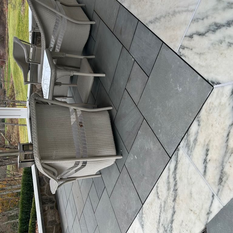 Application image for Marble - White Cloud. The image shows this material being used in a patio pavers application. Dominant colors shown are gray and white. The color mix creates a cool feeling.