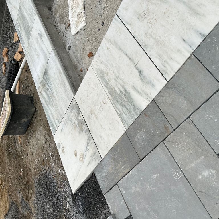 Application image for Marble - White Cloud. The image shows this material being used in a pool coping application. Dominant colors shown are gray and white. The color mix creates a cool feeling.