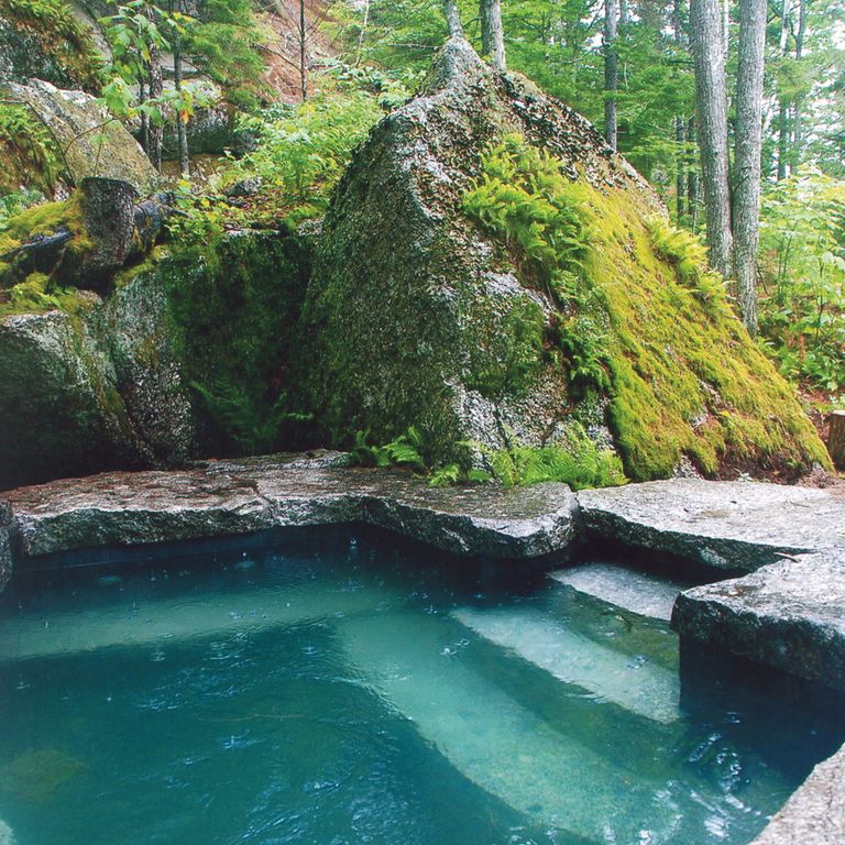 Application image for Granite - Reclaimed New England Quarry Tailings. The image shows this material being used for pool coping and water features. The dominant color shown is gray.