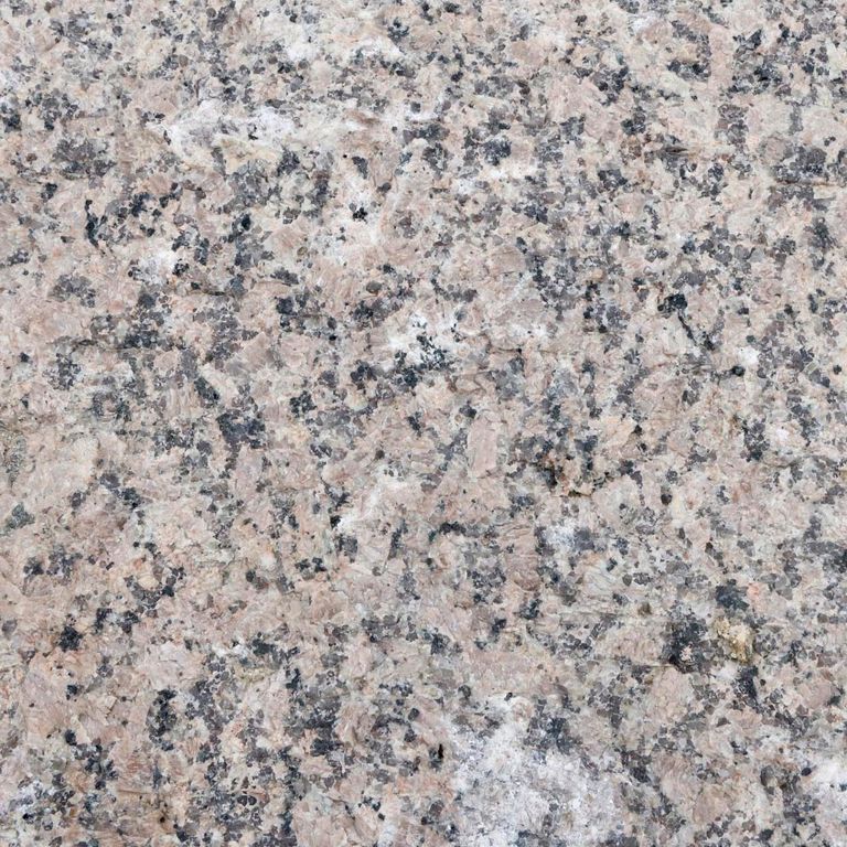 Color/Finish variation image for Reclaimed Granite Curbstone - Junior. The dominant color shown is gray; with beige, pink, purple and white secondaries. Regular, coarse speckled and blotched color patterns.