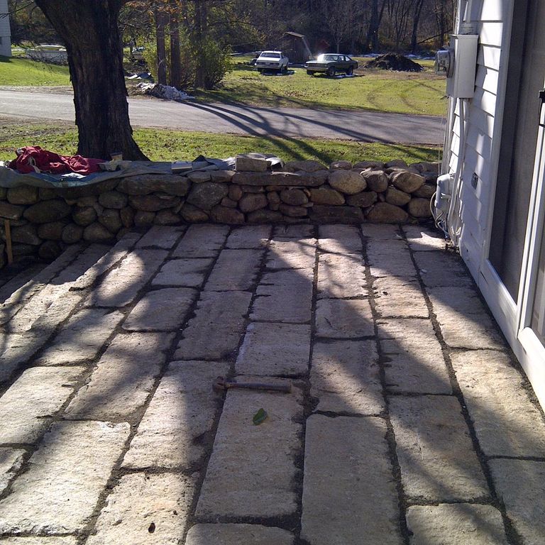 The image shows this material being used in a patio pavers application. The dominant color shown is beige; with brown and orange/rust secondaries. The color mix creates a warm feeling. Regular color pattern.