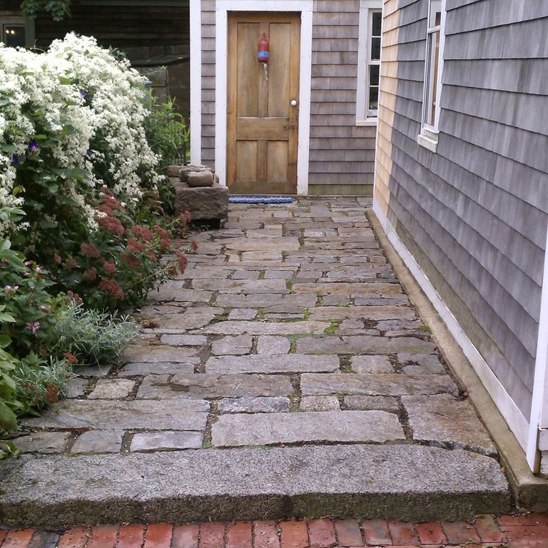 The image shows this material being used in a patio pavers application.