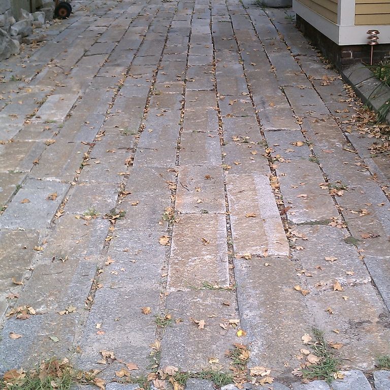 The image shows this material being used in a driveway aprons application. The dominant color shown is gray; with beige, black, blue, brown, orange/rust, white and tan secondaries. The color mix creates a warm feeling. Regular color pattern.
