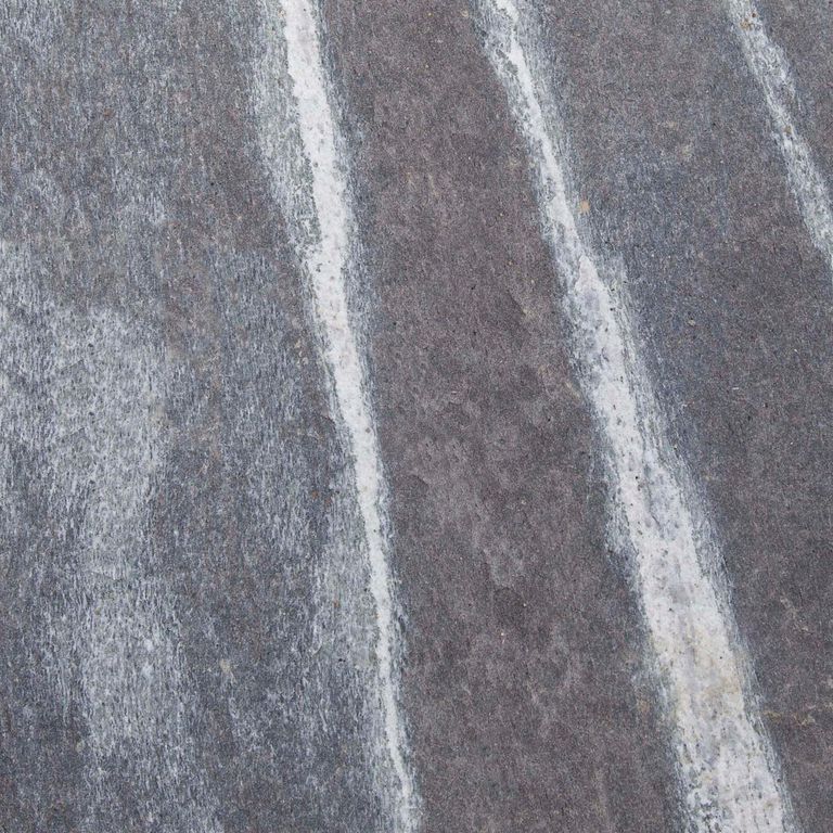 Color/Finish variation image for Mystic Mountain Granite - Flamed. The dominant color shown is gray; with blue, green, purple and white secondaries. Exhibits 
