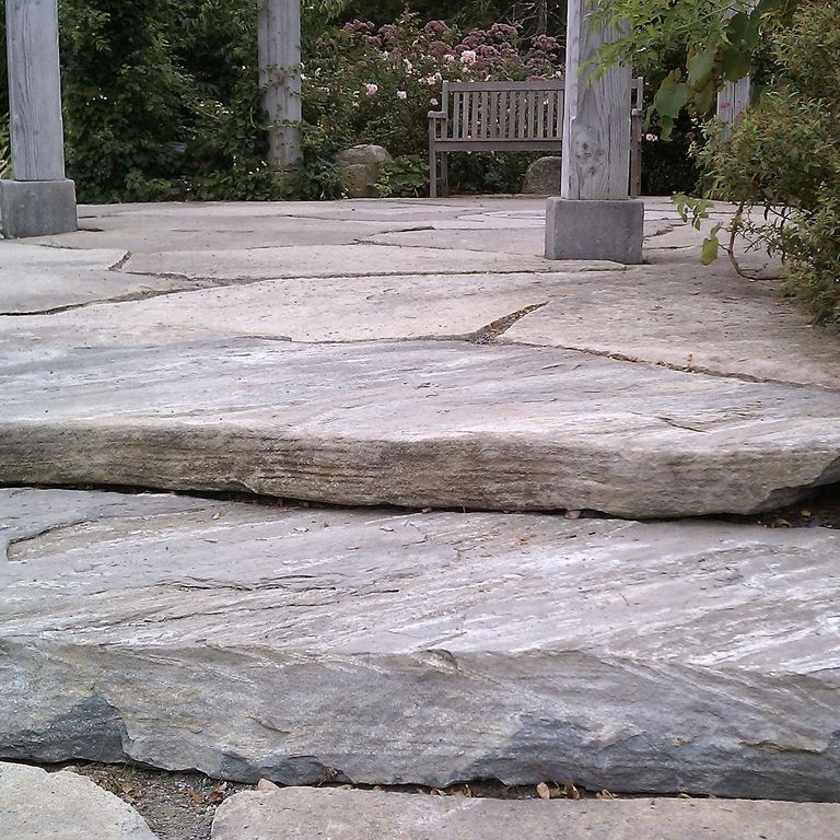 Application image for Mystic Mountain - Natural. The image shows this material being used for patio pavers, landings and monolithic steps. The dominant color shown is gray. Exhibits 