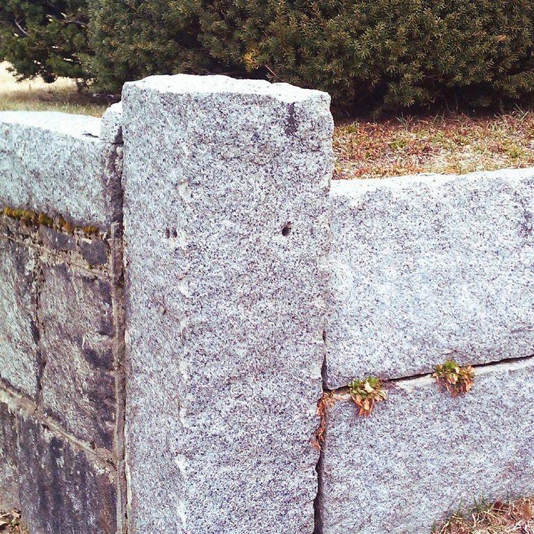 Application image for Reclaimed Granite. The image shows this material being used in a columns application. This is a building and landscape stone for indoor and outdoor commercial and residential applications. Suitable for general use, freeze-thaw conditions, low heat absorption surfaces, high traffic areas, low slipperiness surfaces and high heel compatibilty situations. Moderate to high on the price spectrum.