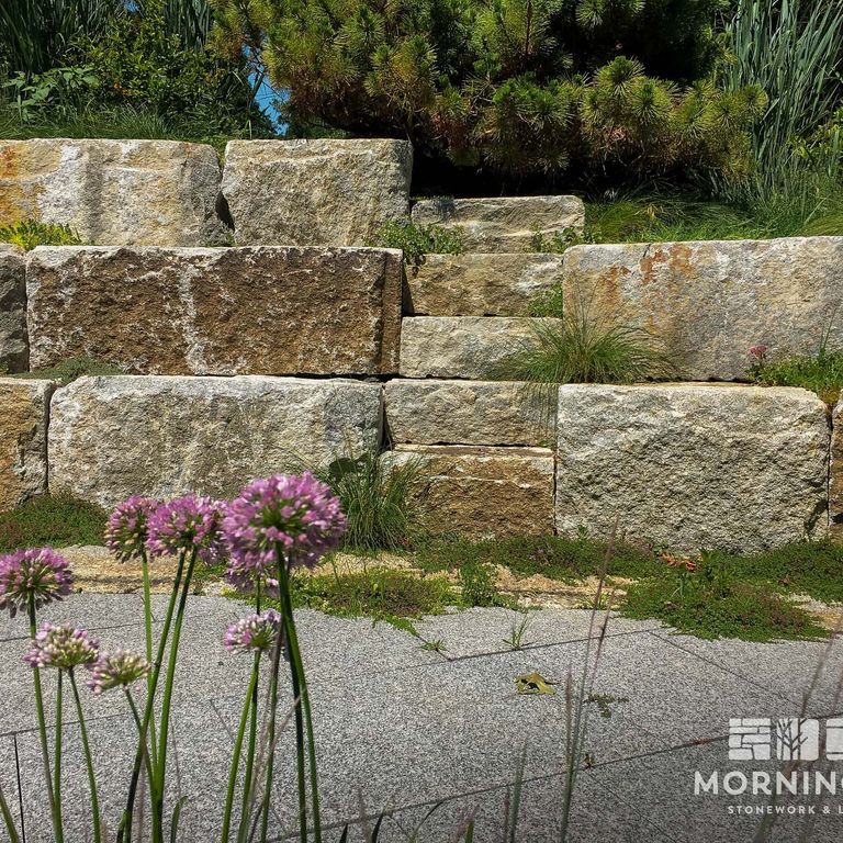 The image shows this material being used in a landscape wallstone application.