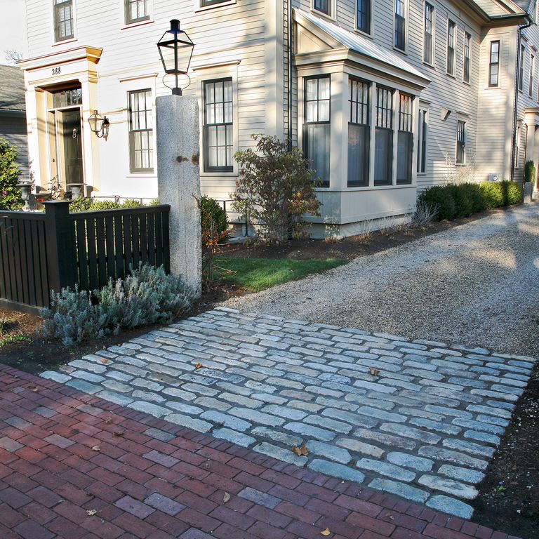 The image shows this material being used in a driveway aprons application. The dominant color shown is gray. Regular color pattern.