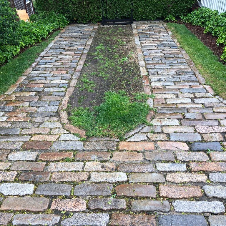 The image shows this material being used in a driveway pavers application.